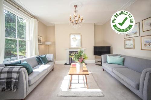a living room with two couches and a tv at City View - 11 Southcot Place in Bath