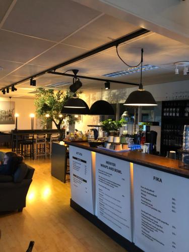 a bar in a restaurant with a counter with menus at Marinan Richters in Fjällbacka
