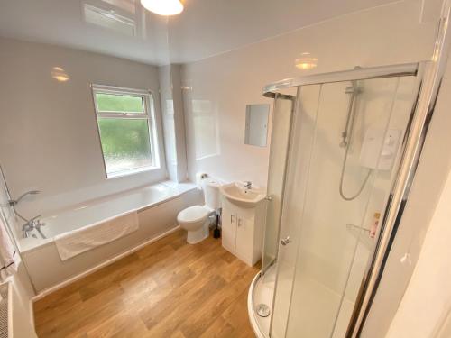 a bathroom with a shower and a toilet and a sink at Warwick Street Professional Lets in Newcastle upon Tyne