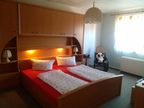 a bedroom with a large bed with a red blanket at Spreewald Ferienwohnung Wollgast in Lübben