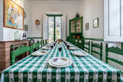a green and white table with plates on it at Mas Barbat in Lilla