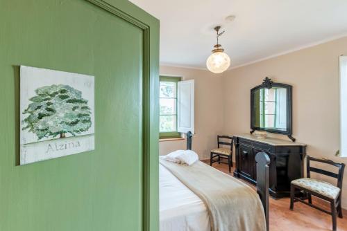 a bedroom with a bed and a desk and a mirror at Mas Barbat in Lilla