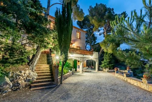 an estate with a staircase leading up to a house at Mas Barbat in Lilla