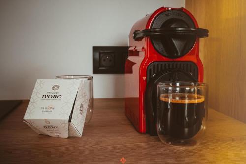 a coffee maker and a glass on a table at Les gîtes de Bouxhmont in Herve