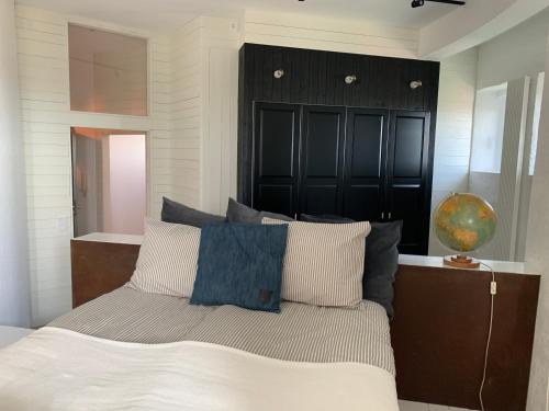 a bedroom with a bed with blue and white pillows at Ystads Gamla Vattentorn in Ystad