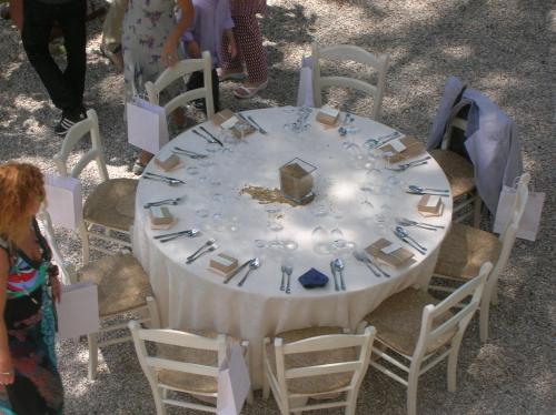 a white table with chairs and a table with plates and silverware at FonteAntica Agriturismo in Norcia
