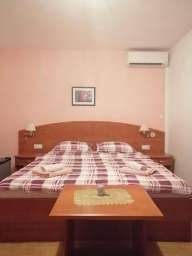 a bedroom with a bed with a table in it at Smještajni objekt Padovan in Banjol