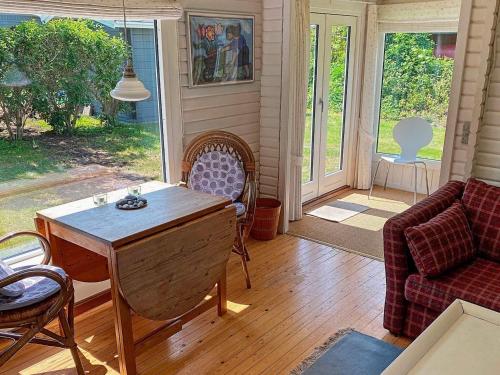 een woonkamer met een tafel en een bank bij 4 person holiday home in Stege in Pollerup Kullegård