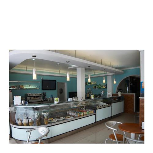 a restaurant with a counter with some food on it at RESIDENCIAL RITA in Odemira