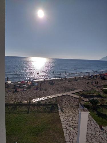 a beach with a lot of people on the water at Nereides Apartments in Agios Gordios