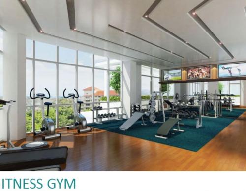 a gym with treadmills and exercise equipment in a building at Furnished Studio Megaworld 7M in Iloilo City