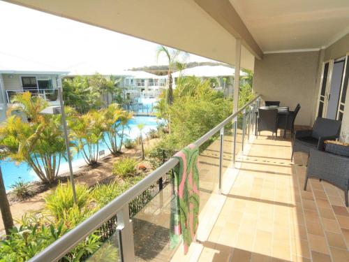 A balcony or terrace at 339 Pacific Blue 265 Sandy Pt Road HUGE RESORT LAGOON POOL