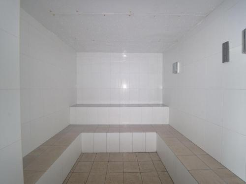 an empty room with white walls and a tile floor at Oaks Pacific Blue 516 private pool aircon WI-FI in Salamander Bay
