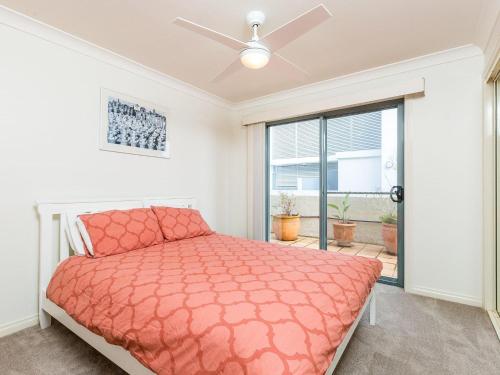 a bedroom with a bed and a window at Peninsula Waters 3 Beautiful Air Conditioned Unit with Pool Lift and WI-FI in Soldiers Point