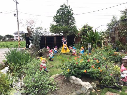 a group of toy figurines in a garden at 花蓮 達芙妮花園民宿 in Jian