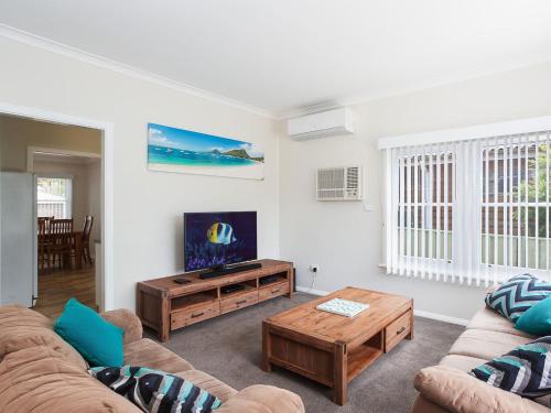 A seating area at Sandy Shoal', 46 Rigney Street - Shoal Bay Beach Cottage with aircon