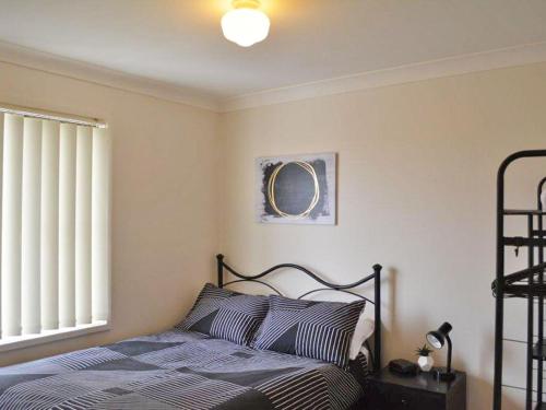 A bed or beds in a room at The Verandah', 9 Hanson Avenue - fantastic child friendly home