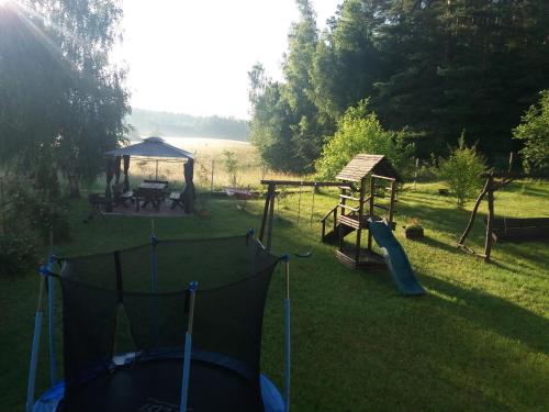 a backyard with a playground with a swing set at Wynajem pokoi WIKI in Mikołajki