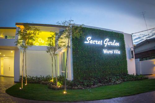 a building with a sign on the side of it at Secret Garden Warni Villa (MUAR) in Muar