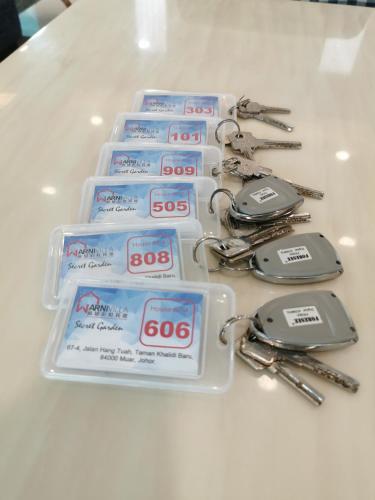 a group of detergents and keys on a table at Secret Garden Warni Villa (MUAR) in Muar