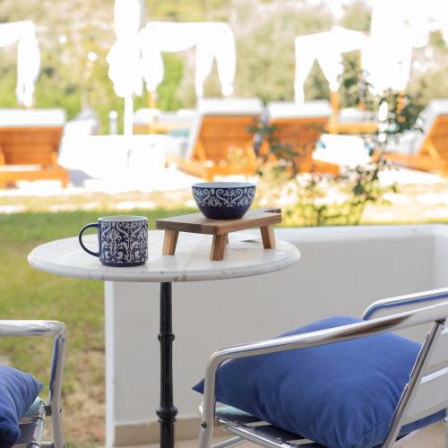 a table with two cups on top of it at Skiathos Avaton Hotel, Philian Hotels & Resorts in Skiathos Town