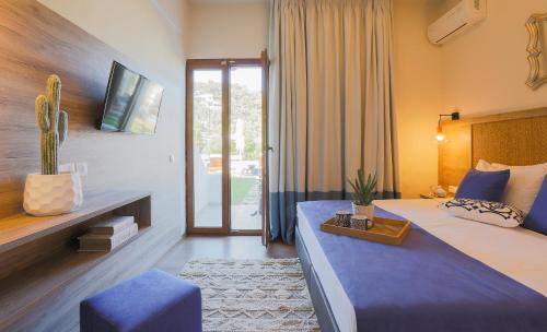 a hotel room with a bed and a cactus at Skiathos Avaton Hotel, Philian Hotels & Resorts in Skiathos Town