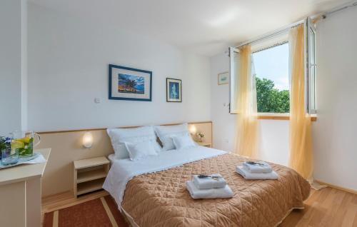 a bedroom with a bed with two towels on it at Apartment Nensi in Poreč