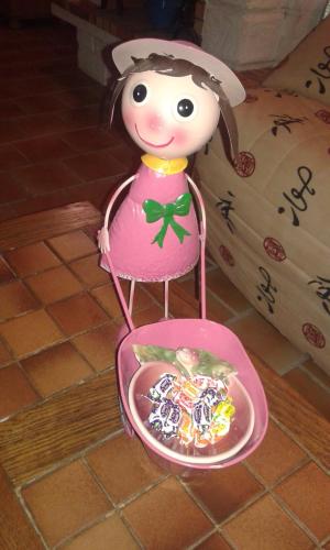 a toy girl in a chair with a bowl of food at Au Grand Sapin Chambres chez l'habitant in Hénonville