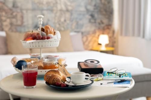 a coffee table with a tray of food on it at Francis B&B Superior in Trieste