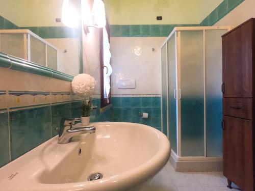 a bathroom with a sink and a shower at Villa Sweet Simius in Villasimius