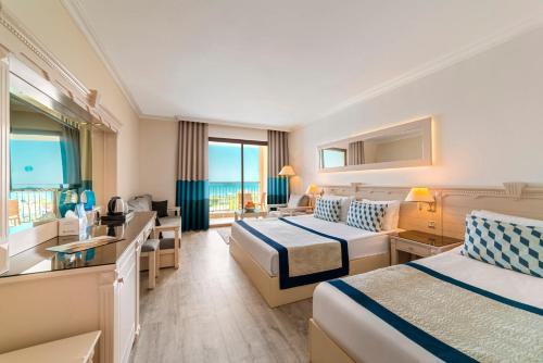 a hotel room with two beds and a view of the ocean at Hotel Turan Prince - Ex Sentido Turan Prince in Side