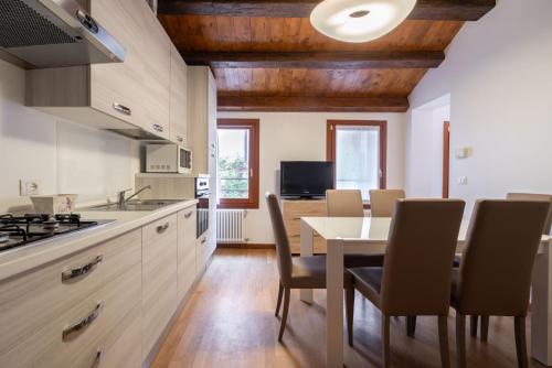 a kitchen and dining room with a table and chairs at Design Palace Apartment by Wonderful Italy in Venice