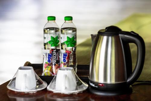 a table with two bottles of water and a tea kettle at Ruan Kanchanok in Pak Chong