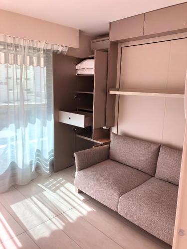 a living room with a couch and a window at Studios Nice Gambetta in Nice