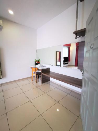 a room with a bed and a table and chairs at Secret Garden Warni Villa (MUAR) in Muar