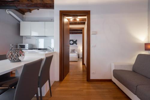 a kitchen and a living room with a couch at Design Palace Apartment by Wonderful Italy in Venice