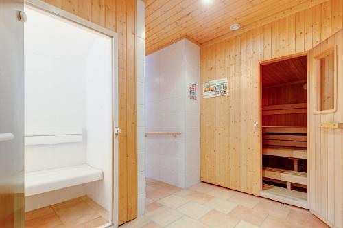a bathroom with a shower and a walk in closet at Hotel Moawirt in Wagrain