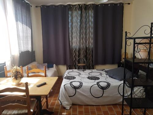 a bedroom with a bed and a wooden table and a table and a tableablish at Appartements Luccisano in Borgo