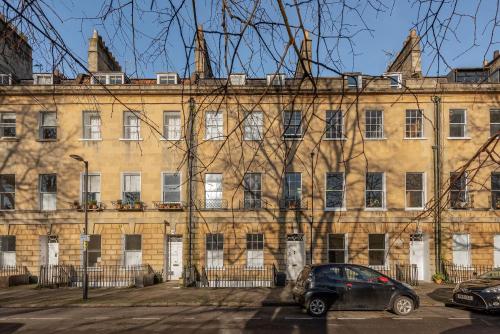 a car parked in front of a large building at Park View Ground Floor 1 Bed Apt in Bath