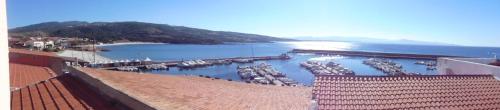 a view of a marina with boats in the water at Fronte mare attico indipendente ed esclusivo con terrazza panoramica in Isola Rossa