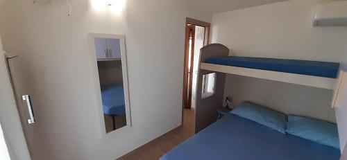 A bed or beds in a room at Fronte mare attico indipendente ed esclusivo con terrazza panoramica