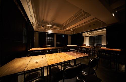 a large wooden table in a room with chairs at EN HOTEL Kyoto in Kyoto