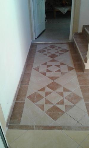 a tiled floor in a hallway with a door at Porcelanico Home in Ofrínion