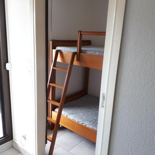 une chambre avec deux lits superposés et une échelle dans l'établissement Acapulco, à Fréjus