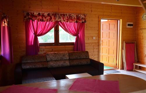 a living room with a couch and a window at Słoneczna Dolina in Kąty Rybackie