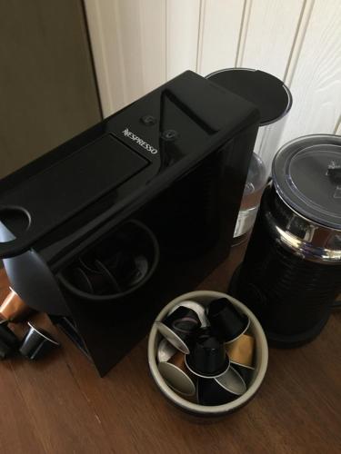 a black coffee machine with a bowl of cups at 40 Bernisdale - The Sabhal in Skeabost