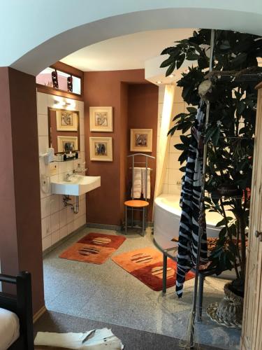 a bathroom with a sink and a bath tub at Waldhotel Auerhahn "Hochkopfhaus" in Todtnau