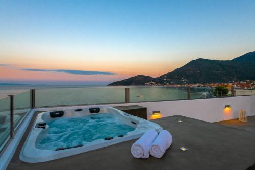 a bath tub with a pair of scissors on a balcony at Paraskevas Boutique Hotel in Tyros