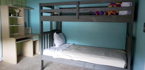 a bedroom with a bunk bed and a desk at Gorham Motor Inn in Gorham