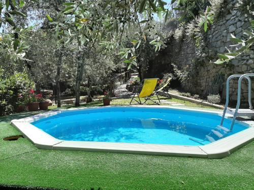 a large pool with a chair and a table at Casa Vacanze Ada in Fiesole